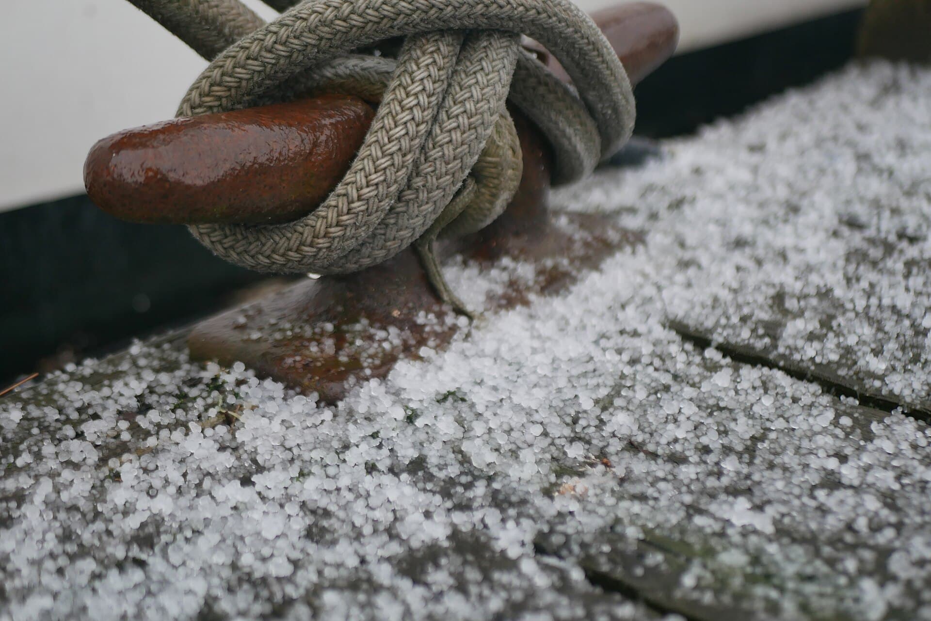 Fresh hailstones piled on the ground after a severe storm