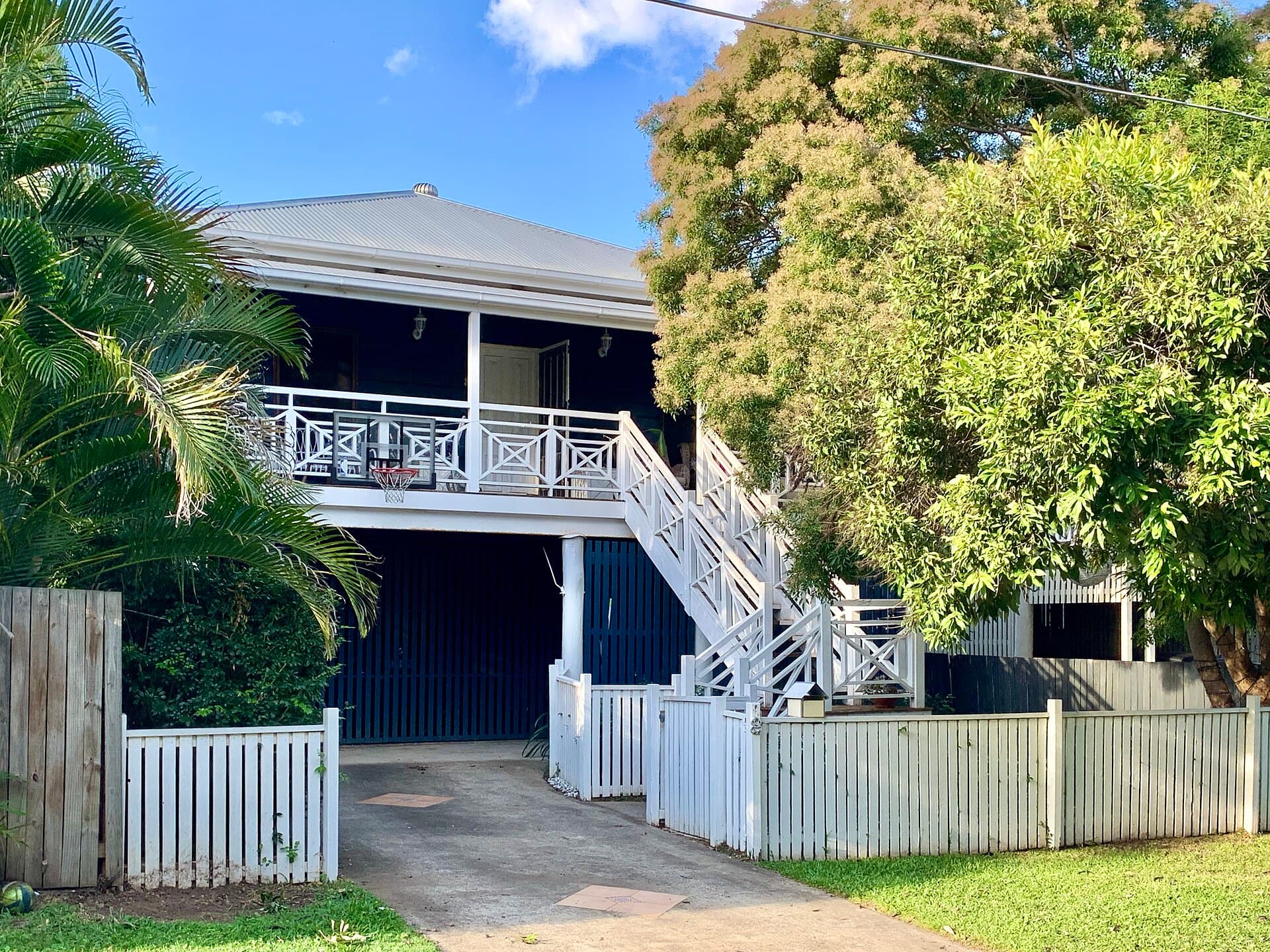 A low-set Corinda house and roofscape, typical of the suburban Brisbane stock that looks finished from the street the day the crew leaves and is only truly tested in the first wet season.