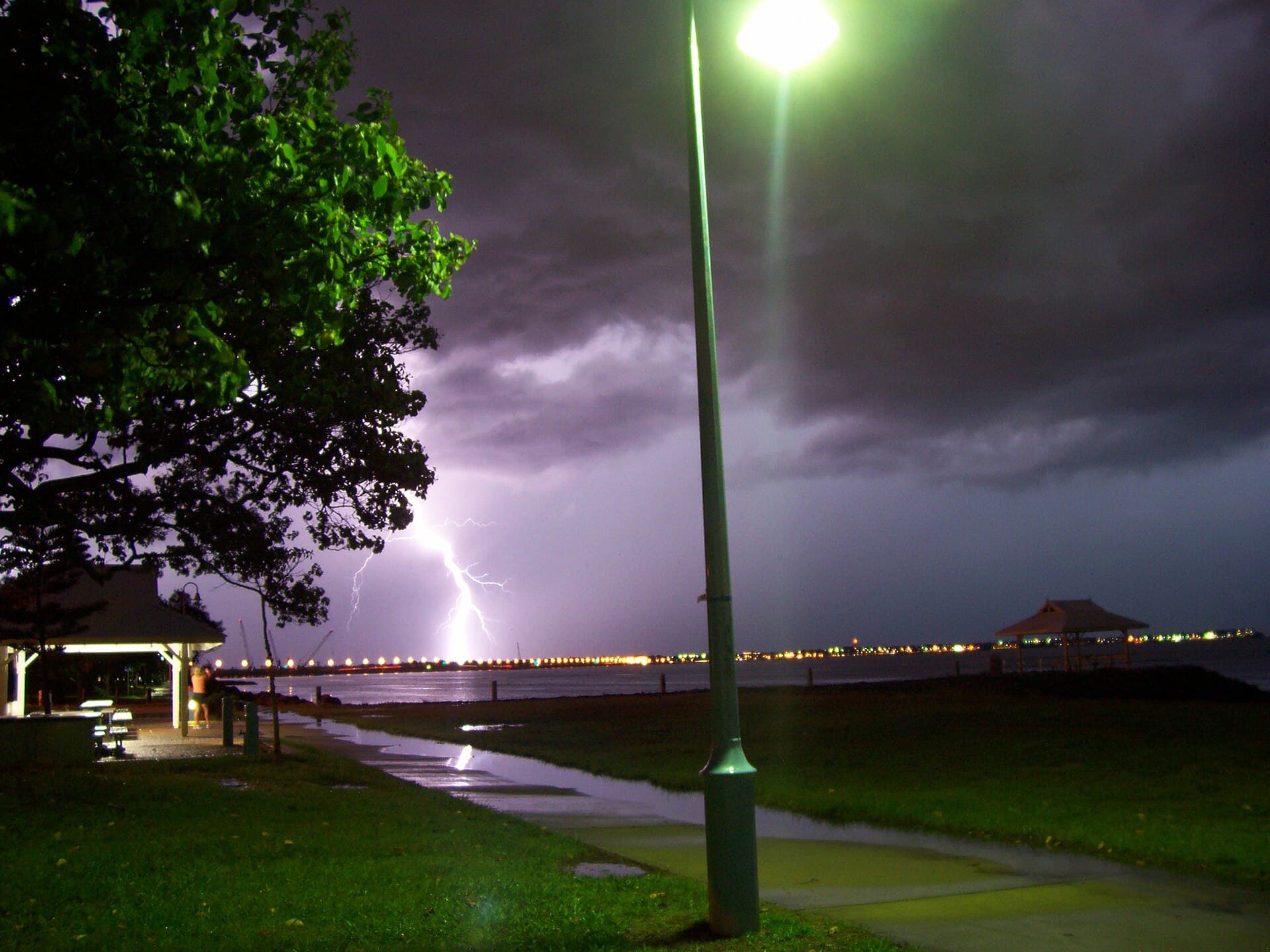 Storm light over Moreton Bay between Brighton and Redcliffe, the kind of late-afternoon cell that tests gutters, valleys and last year’s pointing across the northern suburbs.